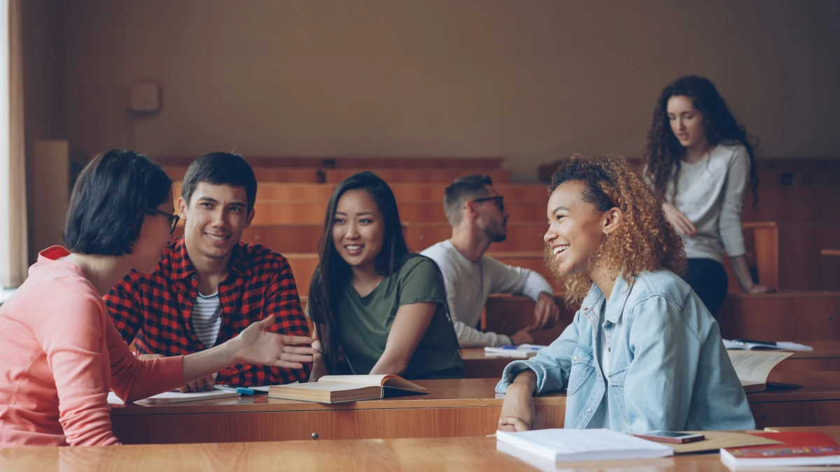 Group of college students engaged in open conversation about university stress and mental health
